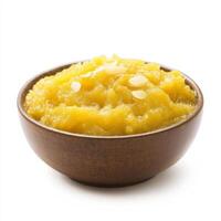 A bowl of moong dal halwa, with a sweet pudding made from mung beans, milk, and sugar, isolated on clean white background. photo