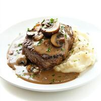 A well crafted shot of a plate of steak Diane, featuring a pan-seared steak in a creamy brandy-mushroom sauce, served with mashed potatoes. The steak Diane, with its rich, savory sauce and tender photo