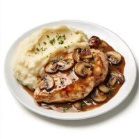 A well crafted shot of a plate of chicken marsala, featuring pan-seared chicken in a rich marsala wine sauce with mushrooms, served with mashed potatoes. The chicken marsala, with its savory mushroom photo
