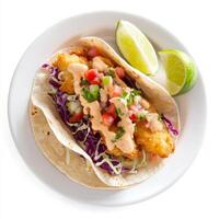 A delicious fish taco platter, with crispy fried or grilled fish, shredded cabbage, pico de gallo, and a creamy chipotle sauce, served on warm corn tortillas with lime wedges. isolated on clean white photo