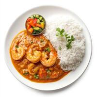 A plate of prawn curry, with prawns cooked in a tangy coconut and tamarind sauce, served with rice and a side of vegetable olan, isolated on clean white background. photo