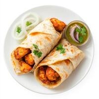 A plate of chicken tikka roll, with grilled chicken tikka wrapped in a flaky paratha, with onions and chutney, isolated on clean white background. photo