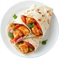 A plate of chicken tikka masala wrap, with chicken tikka masala wrapped in a roti with onions and peppers, isolated on clean white background. photo