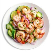 A plate of shrimp and scallop aguachile, shrimp and scallops marinated in lime juice, with cucumbers, red onions, serrano peppers, and avocado, served cold, isolated on clean white background. photo