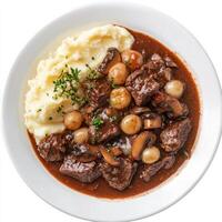 Beef stew with mushrooms and mashed potatoes in a white bowl photo