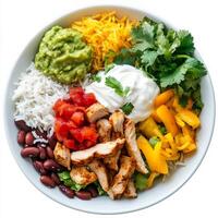 A plate of chicken fajita bowls, chicken fajitas served in a bowl, with rice, beans, guacamole, salsa, and sour cream, topped with fresh cilantro, isolated on clean white background. photo