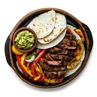 Grilled steak with peppers and guacamole on a plate photo