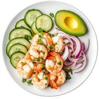 A plate of shrimp aguachile, shrimp marinated in lime juice, with cucumbers, red onions, and serrano peppers, served cold and garnished with avocado slices, isolated on clean white background. photo