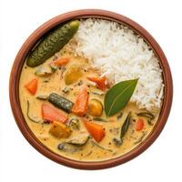 A bowl of vegetable aviyal, with a mixed vegetable curry in a coconut and yogurt sauce, served with rice and a side of pickle, garnished with curry leaves, arranged in a traditional bowl, isolated on photo