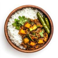 A bowl of vegetable thoran, with a dry curry made from mixed vegetables, coconut, and spices, served with rice and a side of pickle, arranged in a traditional bowl, isolated on clean white background. photo