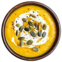 A creamy butternut squash soup, with roasted butternut squash, onions, garlic, and vegetable broth, blended until smooth and creamy, topped with a swirl of coconut cream and toasted pumpkin seeds, photo