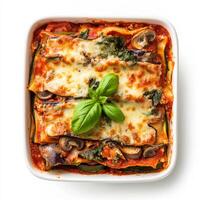 Vegetarian lasagna with mushrooms and spinach in a white dish photo