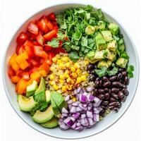 A vibrant bowl of quinoa and black bean salad, featuring fluffy quinoa, black beans, corn, avocado, red onions, bell peppers, cilantro, lime juice, cumin, and a touch of maple syrup, garnished with photo