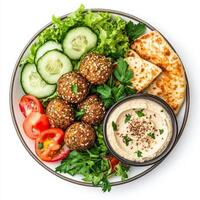 A vibrant plate of falafel bowls, featuring crispy falafel balls, hummus, tahini sauce, lettuce, tomatoes, cucumbers, and a side of pita bread, garnished with fresh parsley and a sprinkle of sesame photo