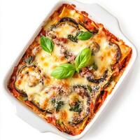 A casserole dish with cheese, vegetables and basil photo
