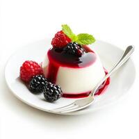 A close-up of a slice of creamy panna cotta, a smooth and delicate Italian dessert, flavored with vanilla and topped with a berry coulis, served in a small glass and garnished with fresh berries and a photo