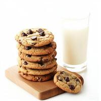 A stack of peanut butter and chocolate chip cookies with a soft, chewy texture, arranged neatly on a wooden board with a glass of milk beside them. Isolated on clean white background photo