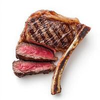 A perfectly grilled tomahawk steak, cooked to a medium-rare perfection, with a beautifully seared crust. The thick bone-in ribeye is sliced to showcase its juicy, marbled texture. Isolated on clean photo