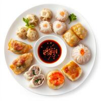 A platter of assorted dim sum, including shrimp dumplings, pork buns, and spring rolls, served with soy sauce and hot chili oil. A traditional Chinese dish. Isolated on clean white background photo