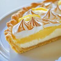 A slice of lemon meringue pie on a plate photo