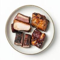 A small plate showcasing different cuts of a single animal, perhaps pork belly, loin, and tenderloin, each cooked in a unique way to highlight its distinct flavor and texture, emphasizing the photo