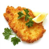 A crispy golden schnitzel with a side of lemon wedges and fresh parsley garnish. The breaded cutlet is fried to perfection, offering a crunchy exterior and tender inside. Isolated on clean white photo