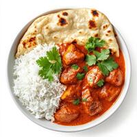 A bowl of fragrant Indian chicken tikka masala, featuring tender, marinated chicken pieces simmered in a rich, creamy tomato-based curry sauce. Served with a side of warm, buttery naan bread and photo