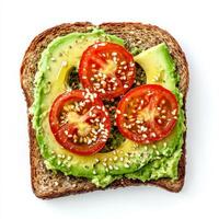 A fresh avocado toast on whole-grain bread, topped with mashed avocado, cherry tomato slices, a sprinkle of sesame seeds, and a drizzle of olive oil. The creamy texture contrasts with the crisp bread, photo