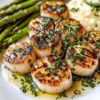Grilled scallops with asparagus and garlic butter photo