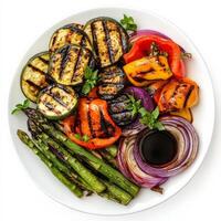 A vibrant platter of mixed grilled vegetables, featuring zucchini, eggplant, bell peppers, asparagus, and red onions, marinated in olive oil and herbs, and grilled until tender and slightly charred, photo