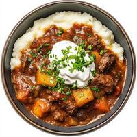 Beef stew with mashed potatoes and sour cream photo
