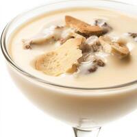 A close-up of a creamy zuppa di funghi dessert, a warm and comforting Italian dessert, with a smooth and creamy custard base, made with heavy cream, sugar, egg yolks, and Marsala wine, flavored with vanilla and served warm in a glass, garnished with ladyf photo