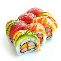 A colorful rainbow sushi roll, filled with fresh crab, avocado, and cucumber, topped with thin slices of tuna, salmon, and shrimp. The roll is garnished with sesame seeds. Isolated on clean white background photo