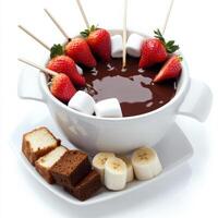 A chocolate fondue with strawberries and bananas photo