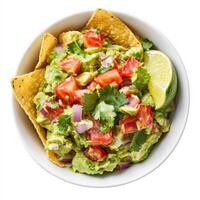 A bowl of fresh guacamole made with ripe avocados, diced tomatoes, red onions, cilantro, and lime juice. The creamy texture is enhanced by the vibrant mix of ingredients, ready to be served with tortilla chips. Isolated on clean white background photo