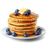 A stack of fluffy pancakes drizzled with golden maple syrup, topped with a pat of melting butter and a handful of fresh blueberries. The layers are perfectly even, making for an irresistible breakfast treat. Isolated on clean white background photo