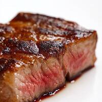 A close-up on the perfectly executed sear of a protein, its caramelized crust contrasting with a raw interior, showcasing the precision and control of temperature and cooking time in fine dining, isolated on clean white background. photo