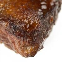 A close-up on a perfectly caramelized crust on meat, vegetables, or even a dessert, emphasizing the importance of temperature and timing in achieving the optimal flavor and texture, isolated on clean white background. photo