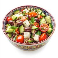 A colorful bowl of Mediterranean quinoa salad with cherry tomatoes, cucumbers, Kalamata olives, feta cheese, and a lemon vinaigrette dressing. A healthy and refreshing dish. Isolated on clean white background photo
