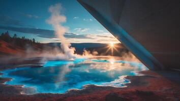 Geothermal Hot Spring Steam Rises in Mountain Landscape at Sunset photo