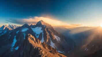 Majestic Mountain Range at Sunrise with Snow-capped Peaks and Golden Light photo