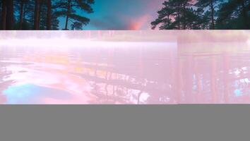 A pink and purple sky with trees and water photo