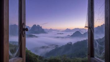 Open Window Overlooking Mountain Landscape Shrouded in Morning Fog photo