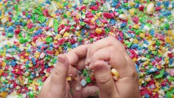 Hands playing with colorful cut soap pieces in ASMR video