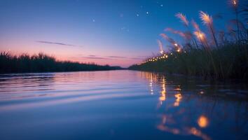 Calm River at Twilight with Grass and Reflecting Lights photo