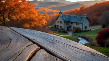 Rustic Wood Table Overlooking Stone House and Colorful Autumn Landscape photo