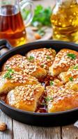 Caramelized chicken sizzling in pan with walnut topping on rustic wooden table with oil herb background photo