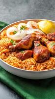 Chicken, rice served in a bowl with onion, lemon on a green cloth. Possible food blog banner photo