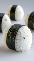 Close-up of rice balls with nori seaweed in a plain background. Food concept photo