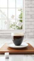 Coffee drink with sugar cubes on desk in front of window food photography photo